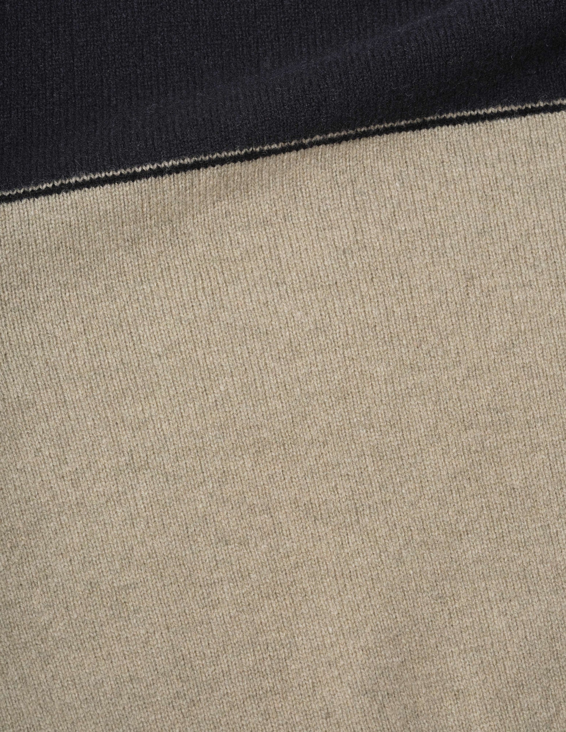 Black and beige lambswool jumper fabric swatch.