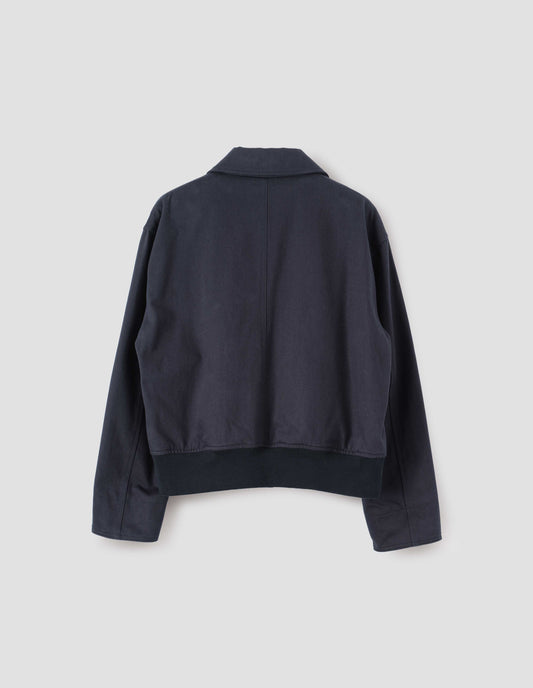 Dark navy collared jacket with ribbed hem, back flat lay view.
