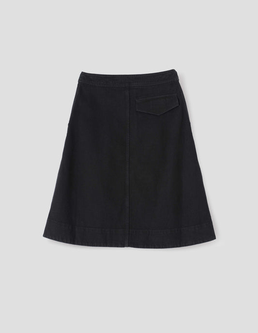 Black A-line skirt with deep stitch hem and back flap pocket, back flat lay view.