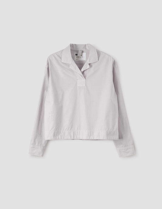 Beige boxy open neck pull-on shirt with box stitch detailing on the placket. Front flat lay view.