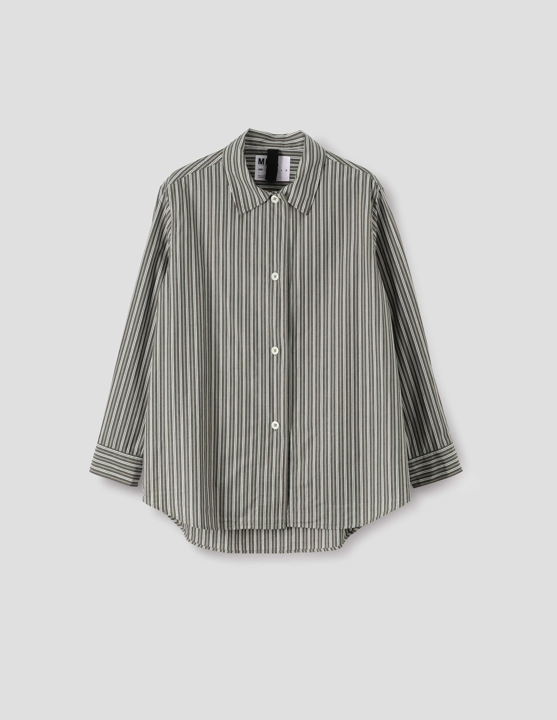 Green, grey and off white striped long sleeve shirt. With wide stitch through placket and corozo brace buttons and cuffs. Front flat lay view.