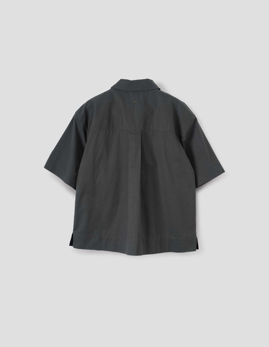 Greenish blue shirt with elbow length sleeves, vent split hem and hanger loop on back yoke. Back flat lay view.