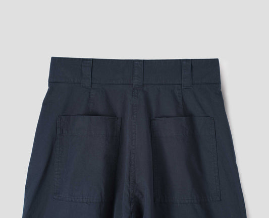 Navy blue trousers with  patch back pockets and deep stitch hem. Back flat lay view. 