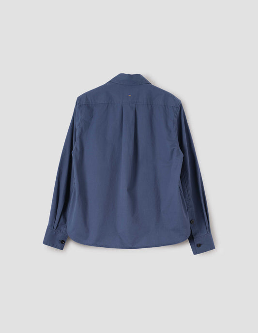 Indigo blue long sleeve shirt, with box pleat on back yoke, corozo button cuffs and curved hem, back flat lay view. 