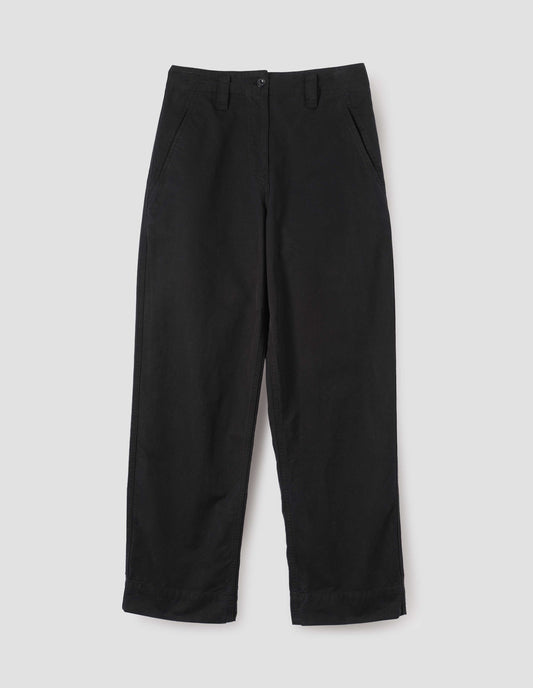 Black cotton canvas trousers with stitch through waistband, button fastening, dropped belt loops and concealed slant pockets. Front flat lay view. 