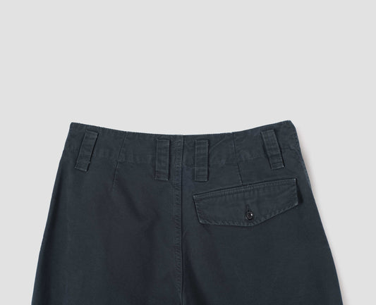 Blue cotton canvas trousers with stitch-through waistband, dropped belt loops and button through flap back pocket. Back flat lay view.