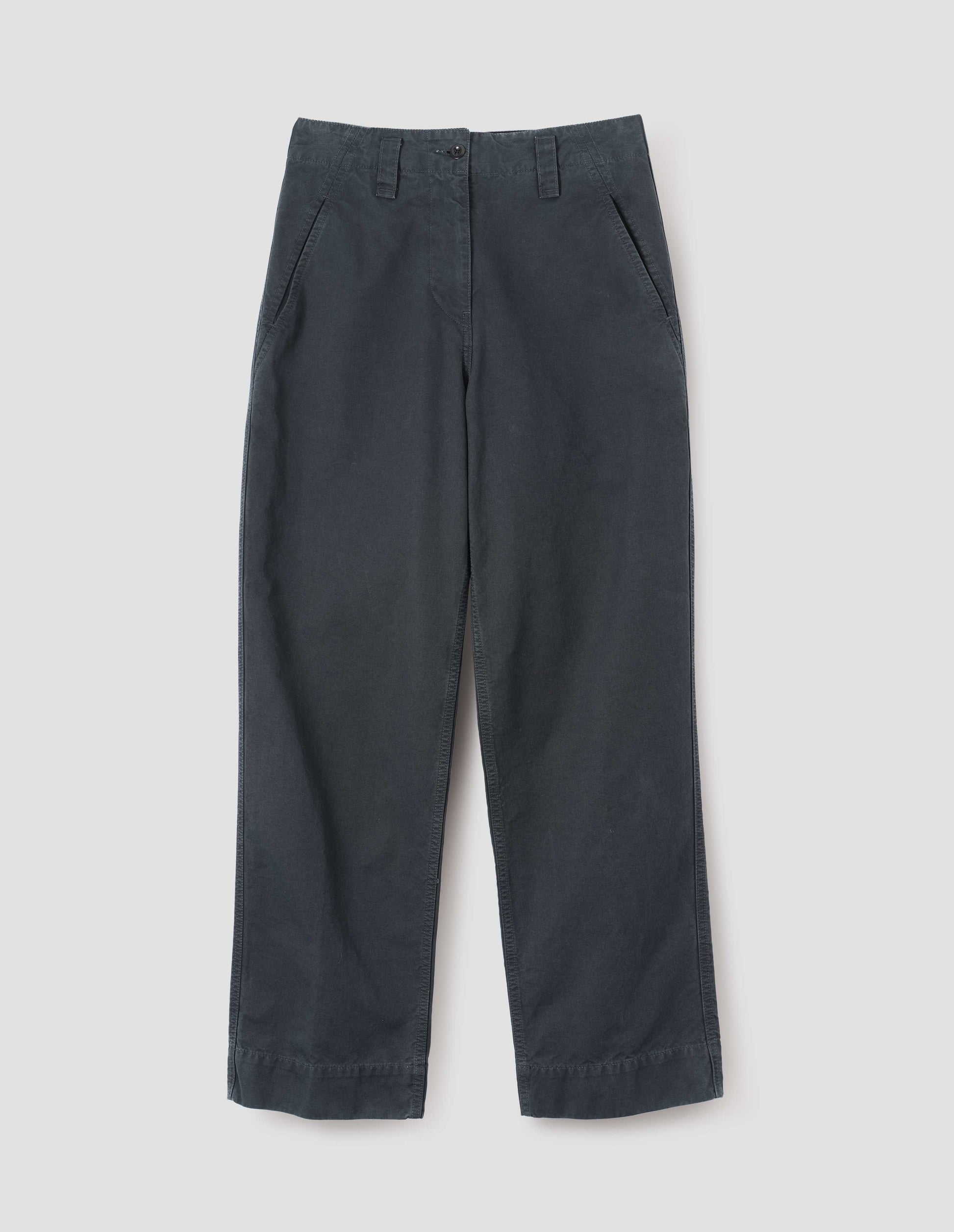 Blue cotton canvas trousers with stitch through waistband, button fastening, dropped belt loops and concealed slant pockets. Front flat lay view. 