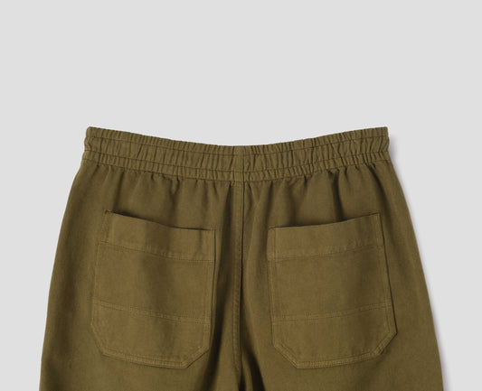 Green joggers with elasticated waistband and patch back pockets with reinforced stitch detailing, back flat lay view.
