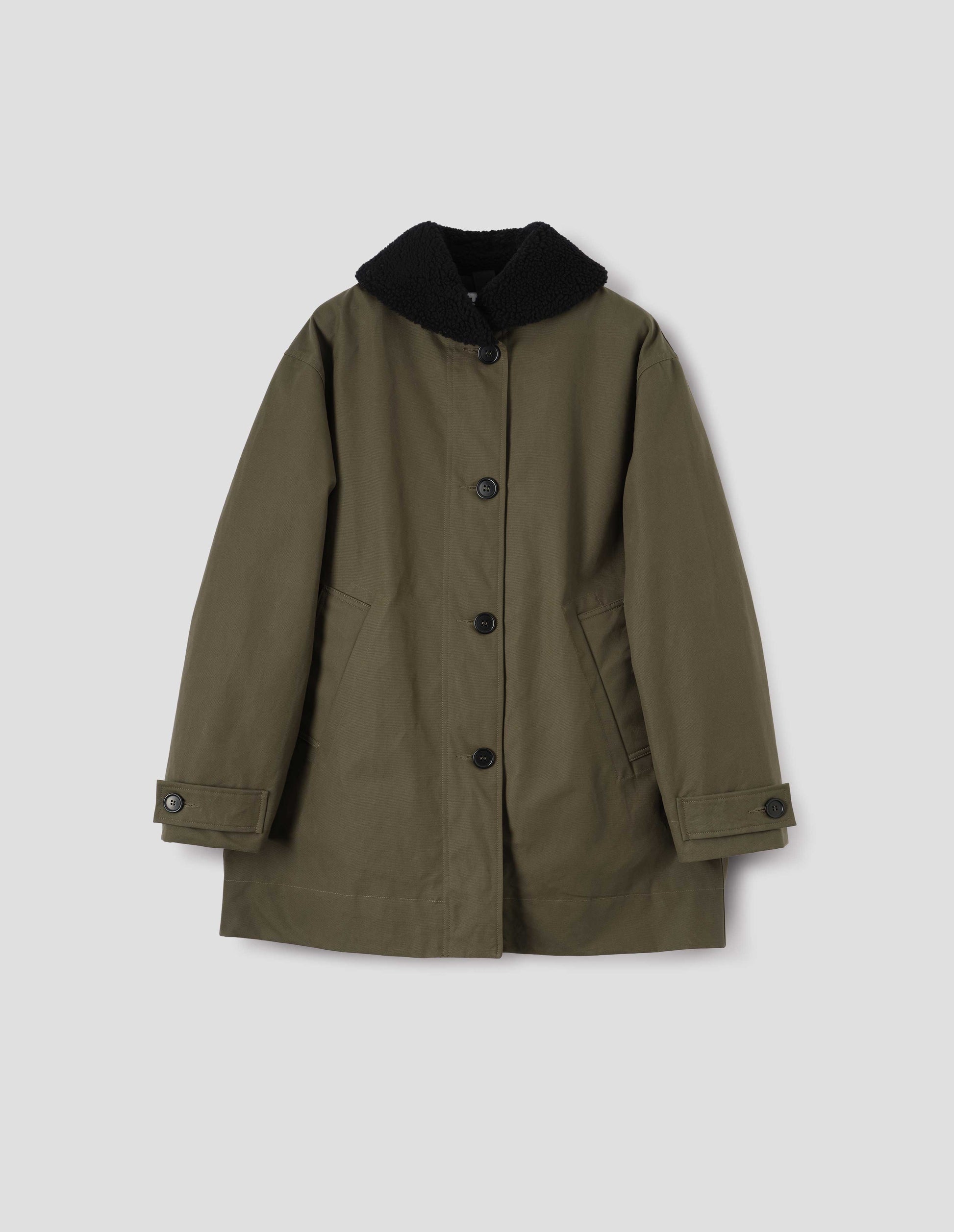 Khaki green coat with black fleece collar, slanted welt pockets with reinforced stitch detailing, corozo brace button fastening and button tab cuff adjusters. Front flat lay view.