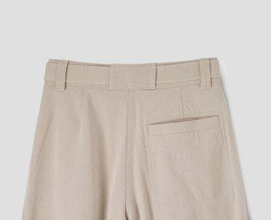 Beige wide leg trousers with stitch through back welt pocket, belt loops and removable webbing belt with metal slide adjuster. Back flat lay view.