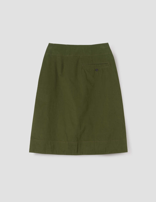 Green skirt with deep wrap, slant side pockets and concealed back pocket, back flat lay view.