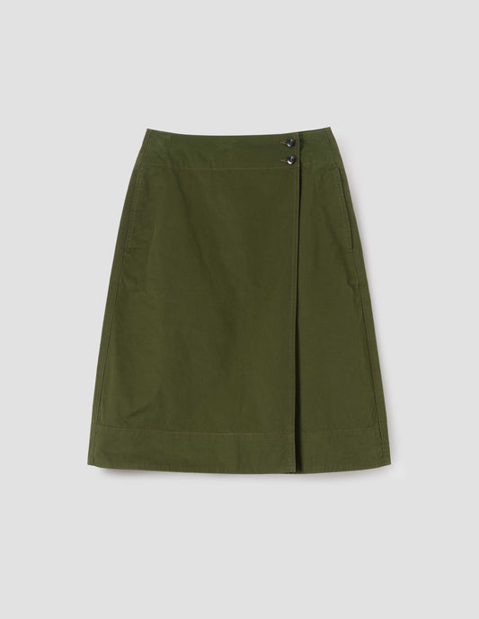Green skirt with deep wrap, slant side pockets and corozo button fastening, front flat lay view.