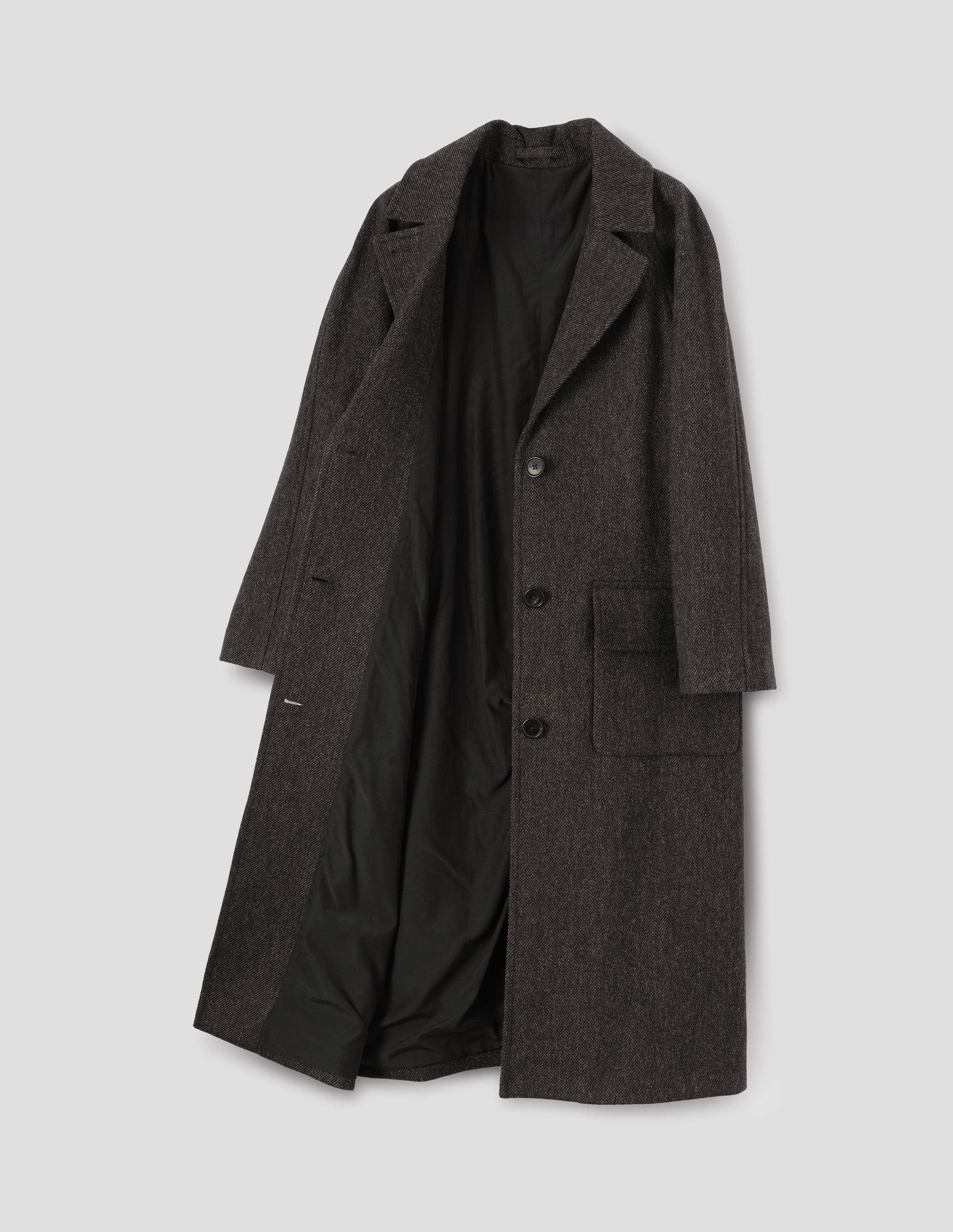 Brown wool longline overcoat with raglan sleeve, button fastening lapel and deep flap patch pockets and fully lined in black cotton. Front flat lay open view.