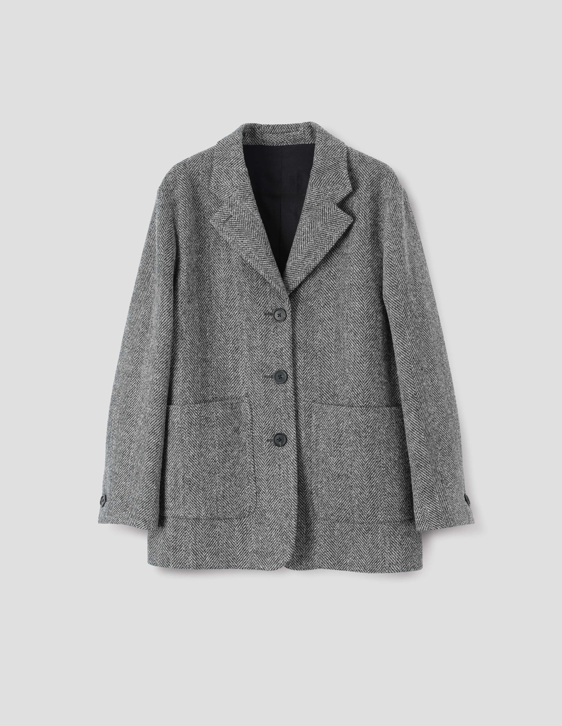 Grey and black herringbone blazer with large patch pockets, horn buttons on lapel and cuffs, front flat lay view.