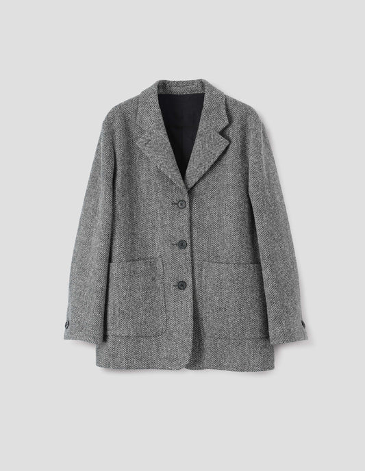 Grey and black herringbone blazer with large patch pockets, horn buttons on lapel and cuffs, front flat lay view.