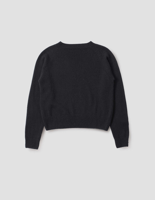 Black long sleeve cashmere jumper, with raglan sleeve and contrasting rib on neck, cuffs and hem. Back flat lay view.