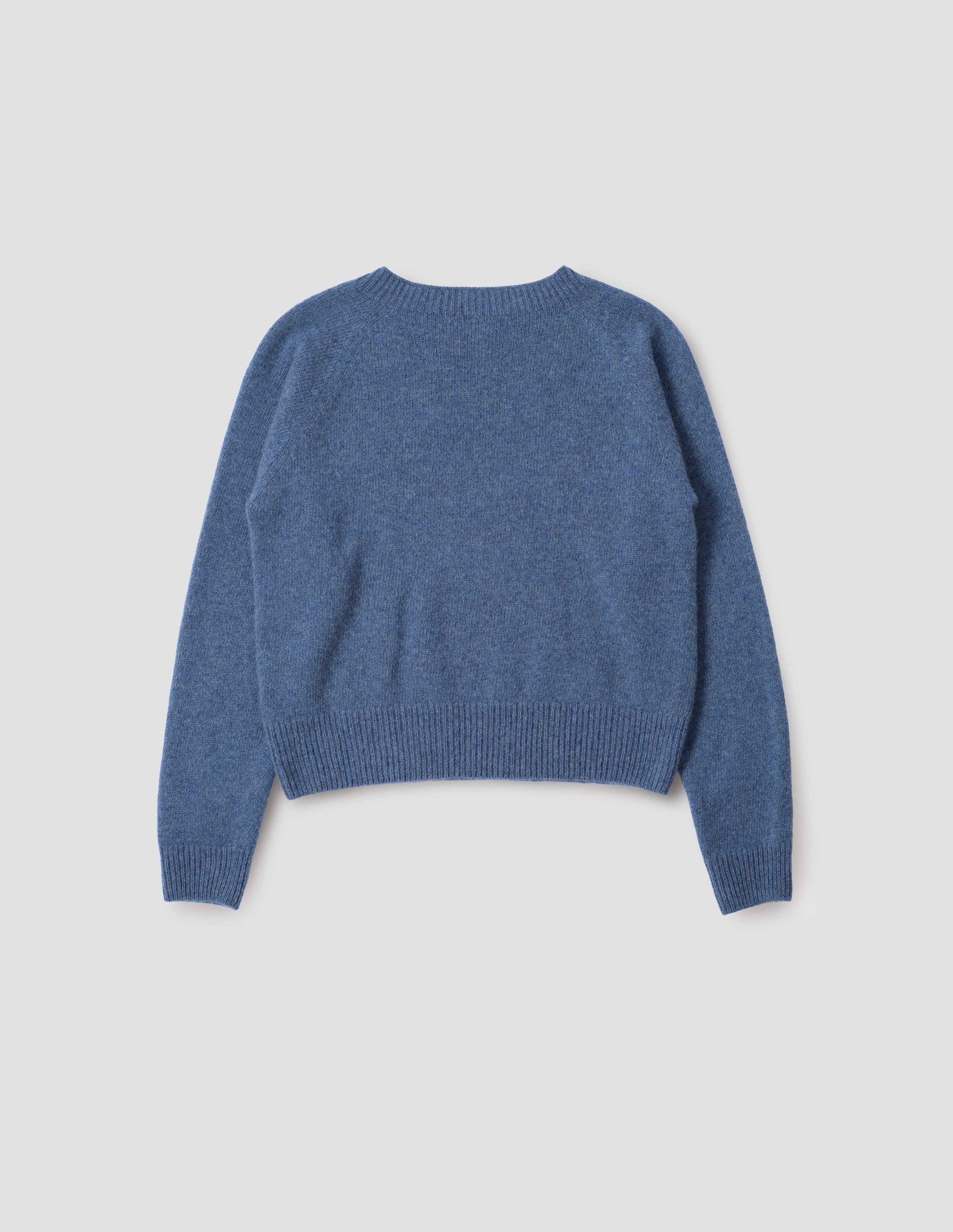Blue long sleeve cashmere jumper, with raglan sleeve and contrasting rib on neck, cuffs and hem. Back flat lay view.