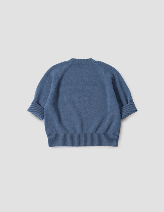 Blue short sleeve crew neck jumper with raglan sleeves, wide ribbed hem and turned up wide ribbed cuffs, back flat lay view.