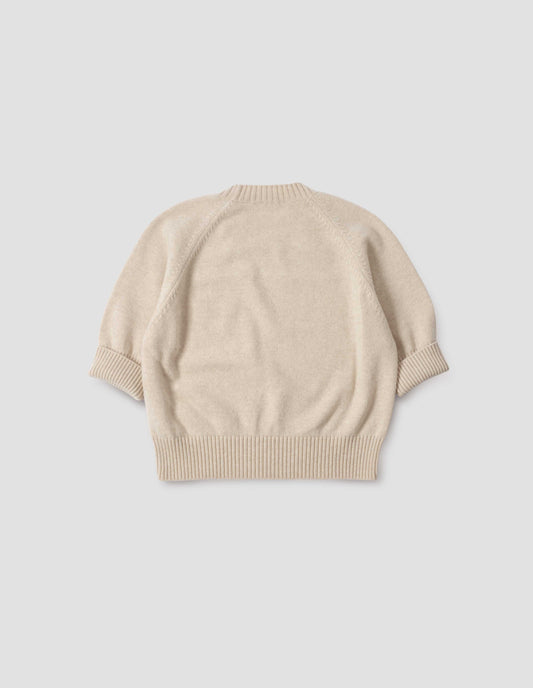Beige short sleeve crew neck jumper with raglan sleeves, wide ribbed hem and turned up wide ribbed cuffs, back flat lay view.
