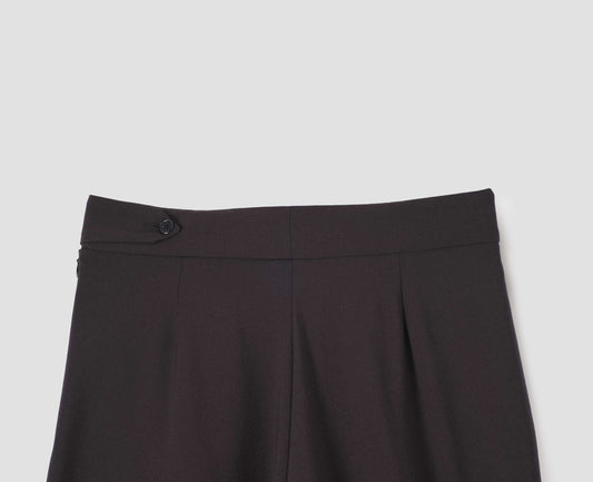 Brown double pleated wool trousers, with concealed side zip and pull through tab side fastening. Back flat lay view. 