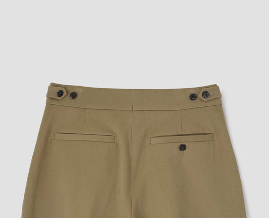 Dark beige trousers with horn button tabs on waistband, welt back pocket and button-through welt back pocket, back flat lay view.