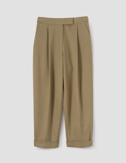 Dark beige tapered and pleated trousers with hook and bar fastening, tabs on waistband, side pockets and cuffed hems, front flat lay view.
