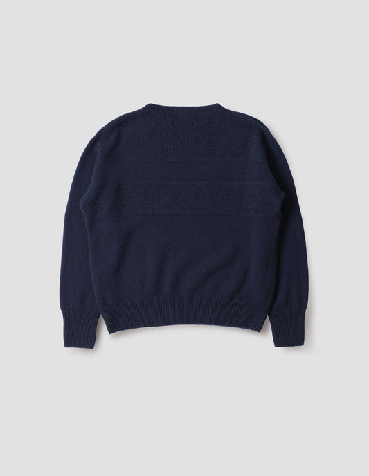 Navy blue crew neck jumper with textured panelling on shoulders and back and contrasting rib on neck, cuffs and hem, back flat lay view.
