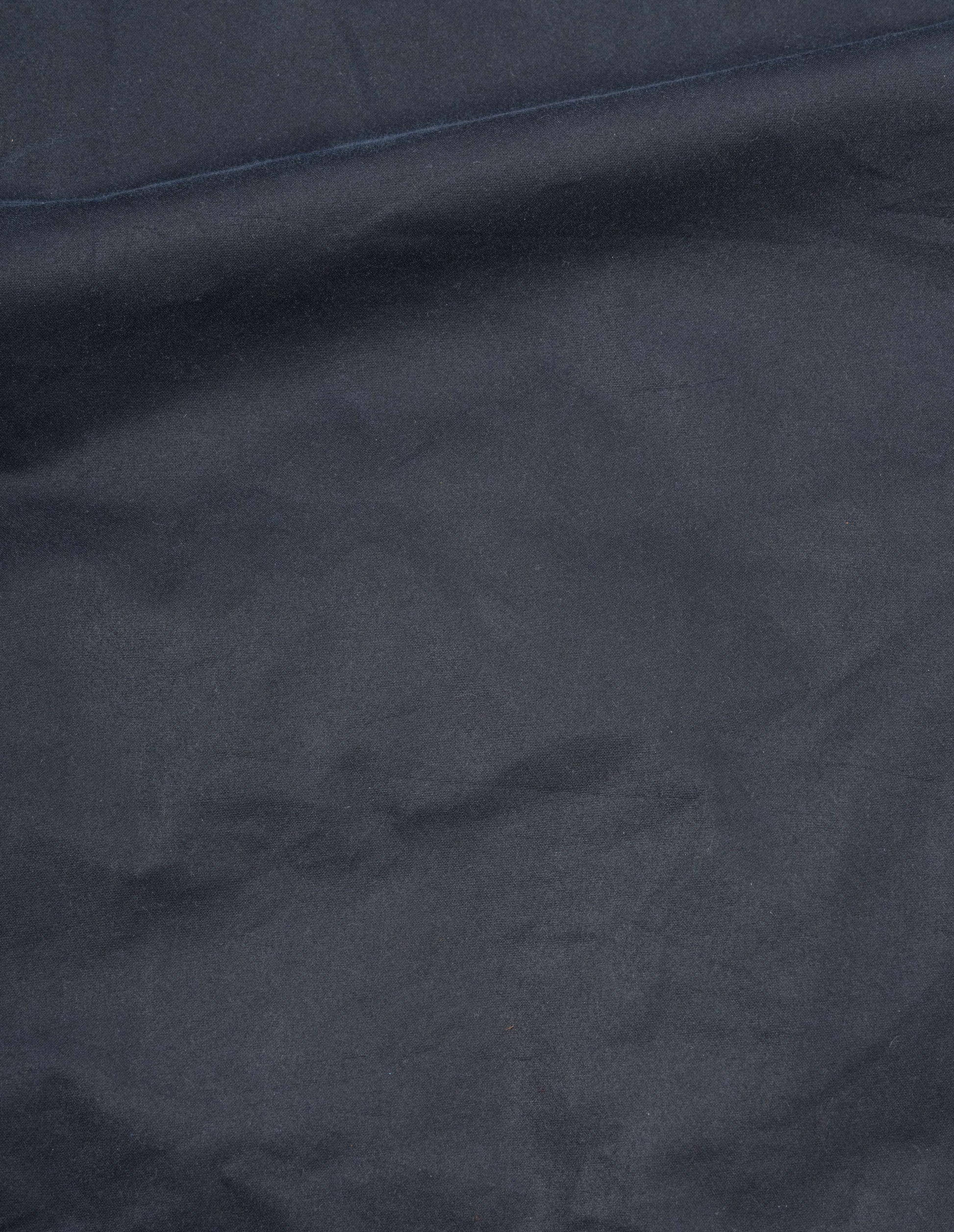 Dark blue waxed cotton jacket fabric swatch.