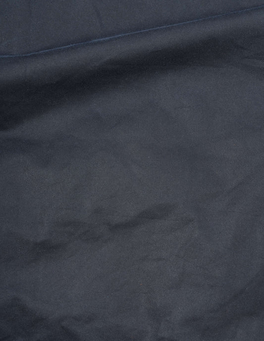 Dark blue waxed cotton jacket fabric swatch.