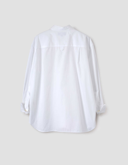 White shirt with hanger loop detail on back yoke and turned up cuffs with mother of pearl buttons. Back flat lay view.