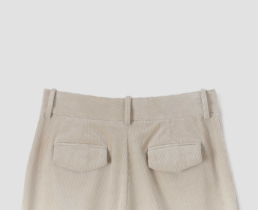 Beige corduroy long leg trousers, with belt loops and concealed button fastening flap back pocket. Back flat lay view.