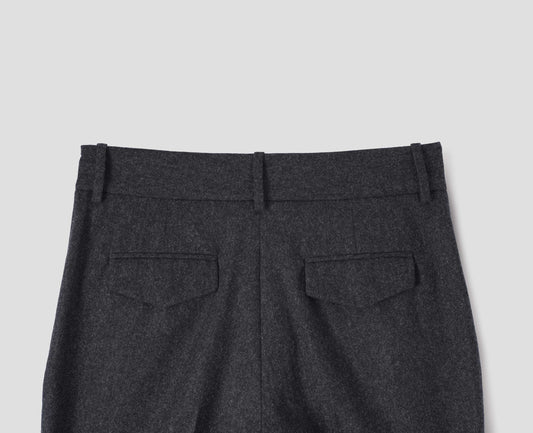 Charcoal grey wool trousers with slant side pockets, belt loops and flap back concealed pockets. Back flat lay view.