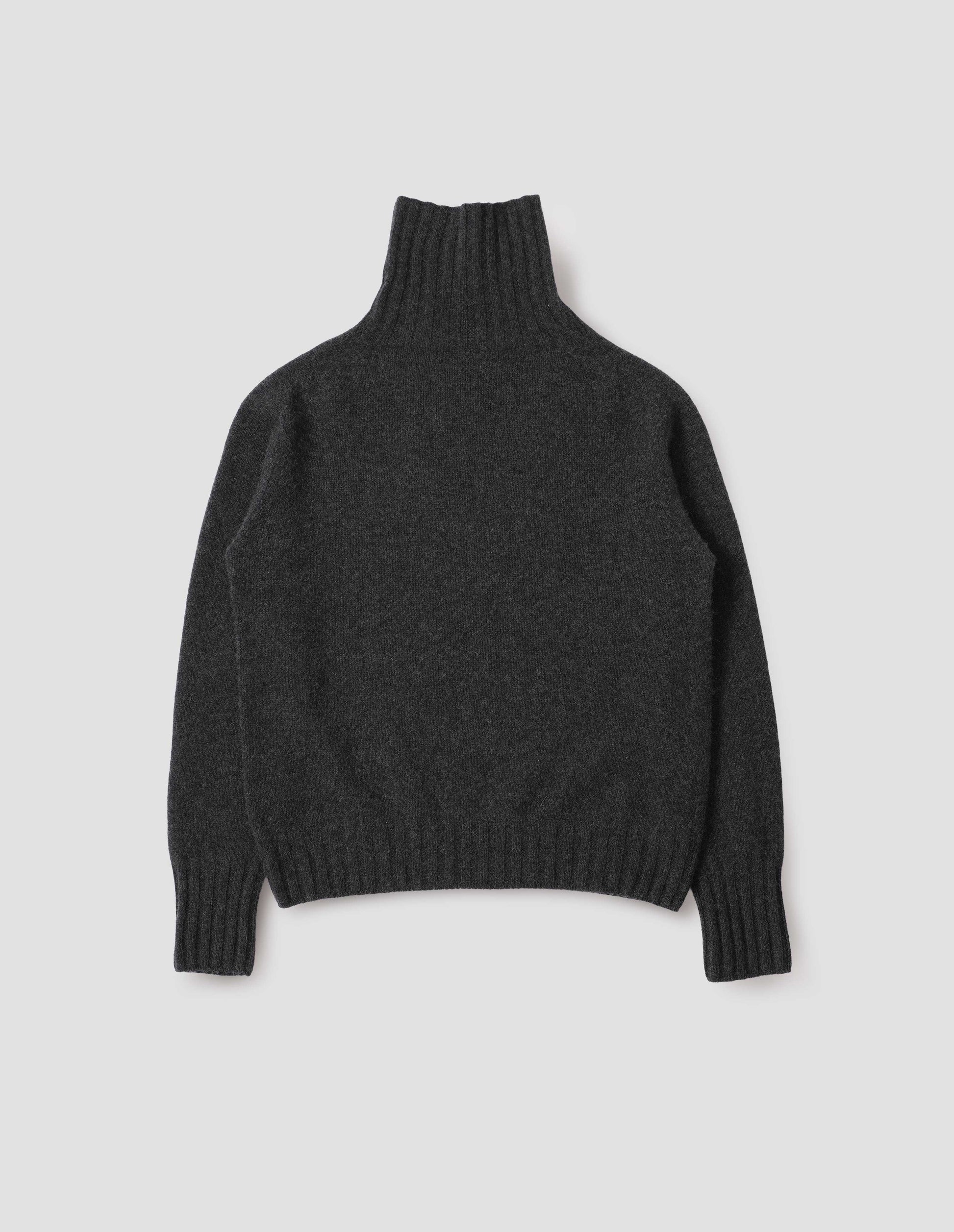 Charcoal grey high neck cashmere jumper, with saddle sleeve and contrasting wide rib on neck, cuffs and hem. Back flat lay view.