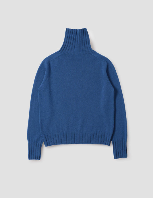 Blue high neck cashmere jumper, with saddle sleeve and contrasting wide rib on neck, cuffs and hem. Back flat lay view.