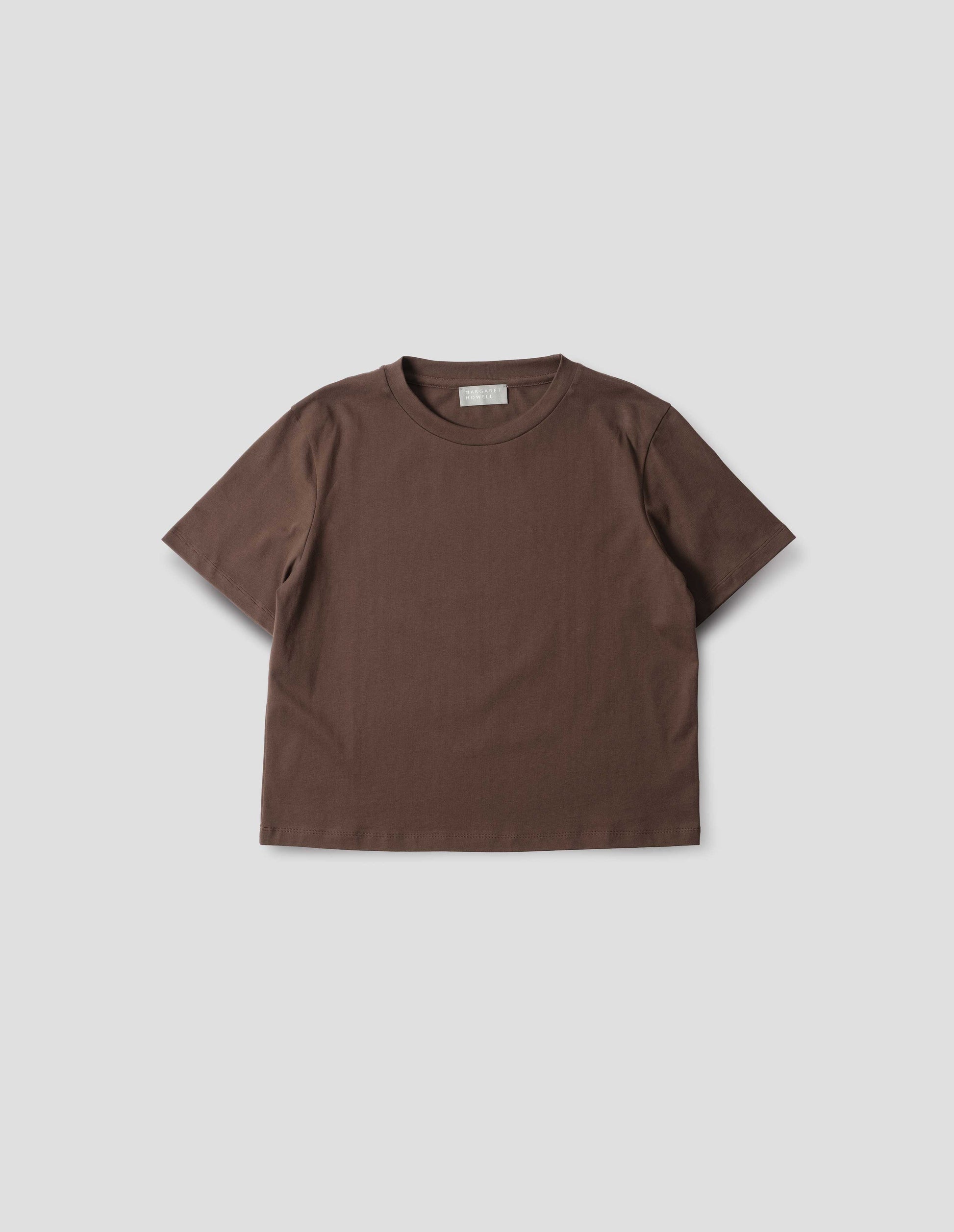 Dark brown jersey t-shirt with crew neck. Front flat lay view.