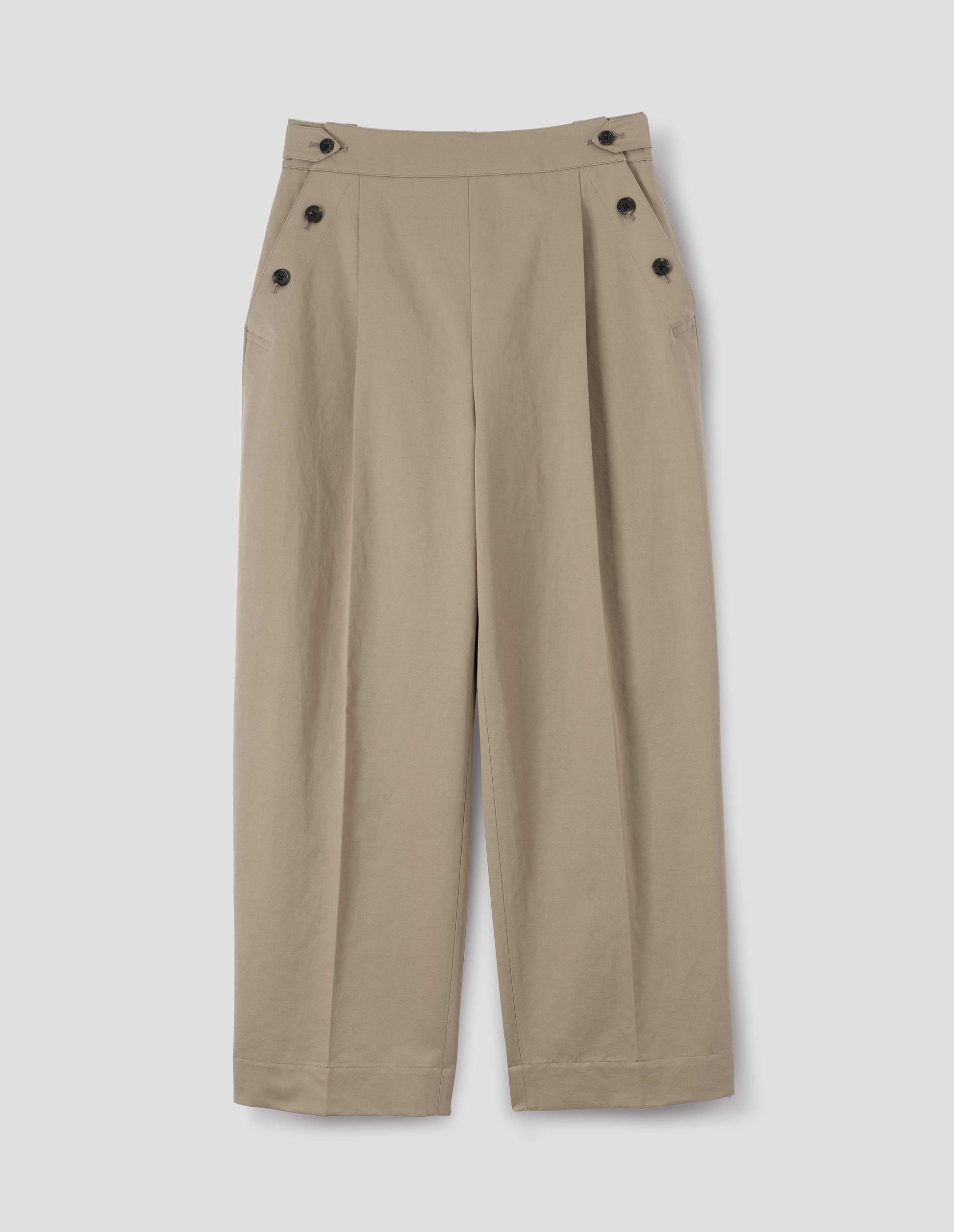 Beige cotton linen pleated trousers with horn button side cinches and three horn button closures on both sides, and with stitch-through hem. Front flat lay view.