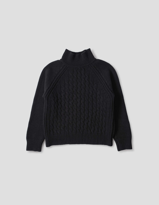 Black merino jumper with ribbed high neck collar, front cable design, raglan sleeves with ribbed side seams, cuffs and hem. Front flat lay view.