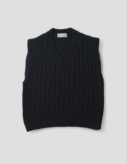 Black wool slipover with V neck, front cable design and ribbed neck, armholes, side seams and hem. Front flat lay view.