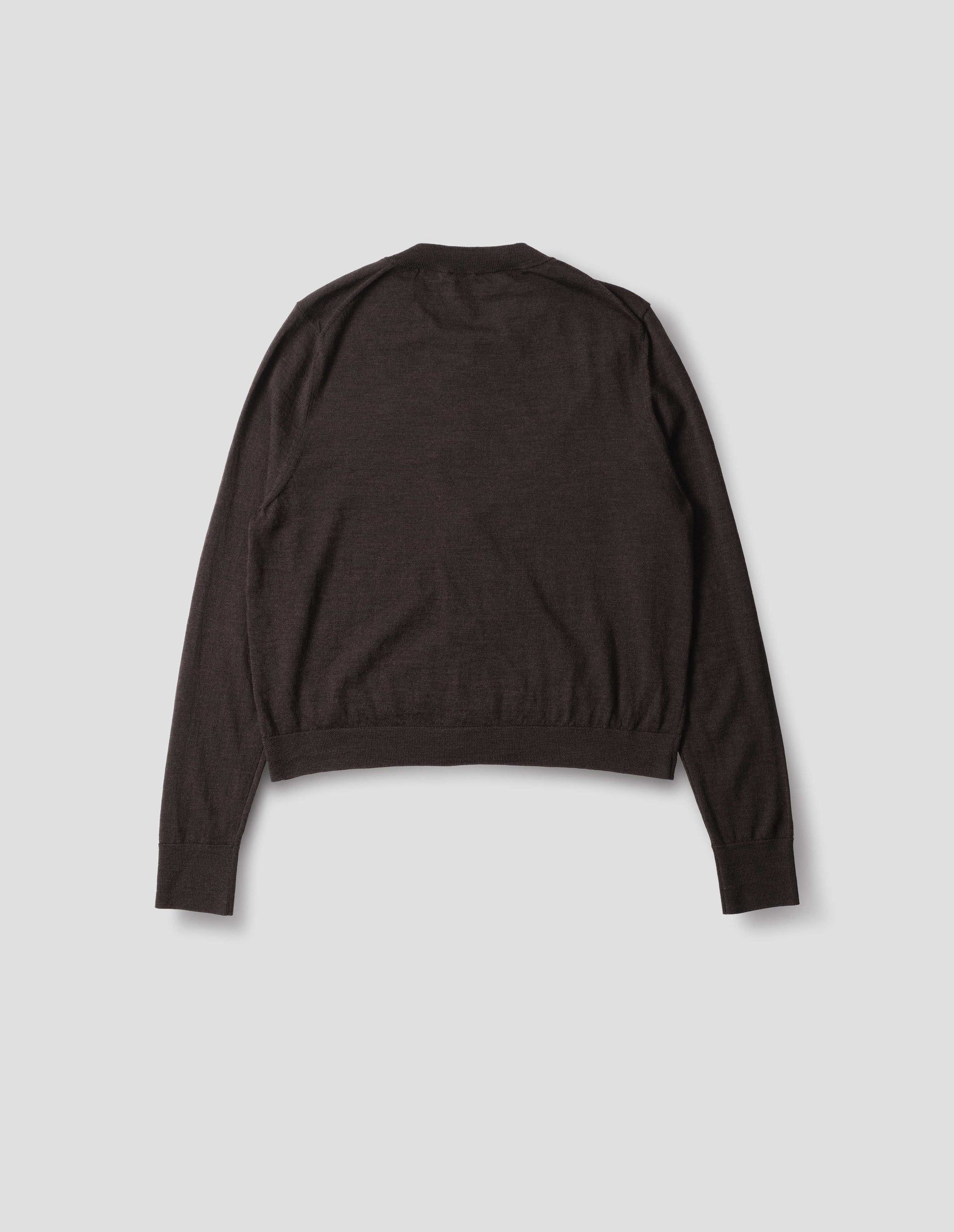 Dark brown merino cardigan with fully fashioned sleeves, French shoulder offset on back seam, and ribbed neck, cuffs and hem. Back flat lay view.