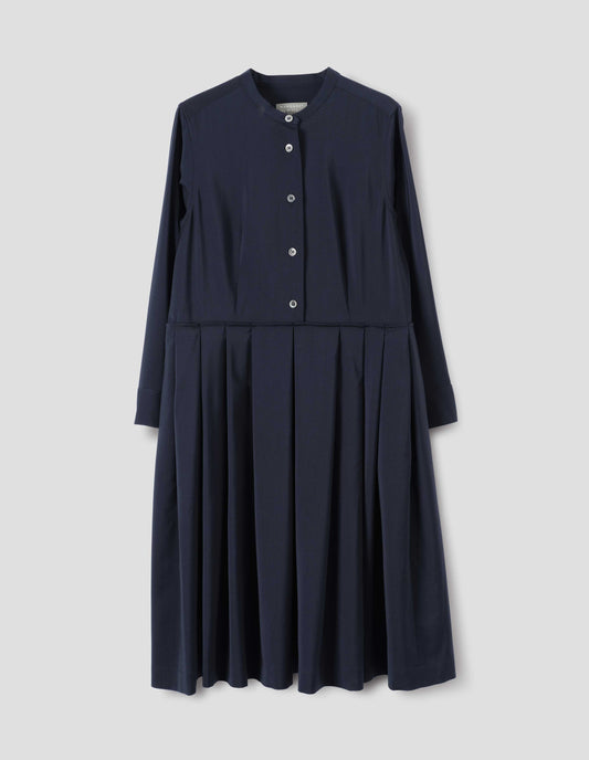 Dark blue collarless wool dress with mother of pearl buttons on half placket, long sleeves with shirt cuffs, and pleated skirt with concealed side pockets. Front flat lay view.