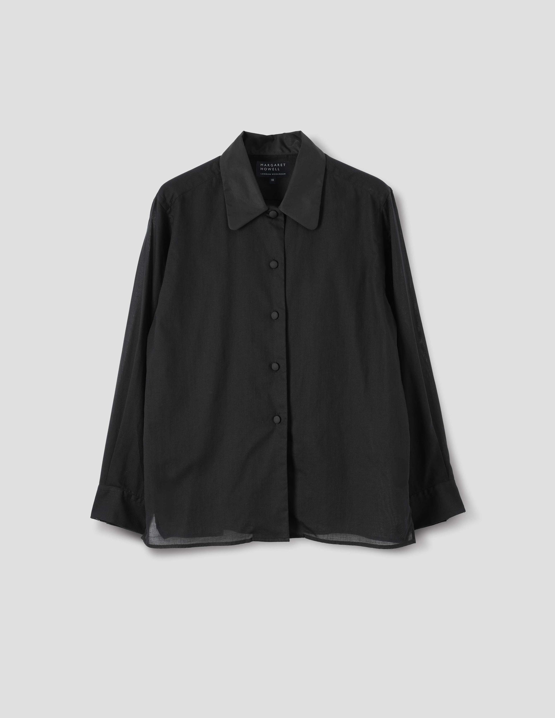 Black cotton cashmere shirt with contrast cotton poplin collar, covered domed buttons on placket and cuffs, and with deep vent split hem. Front flat lay view.