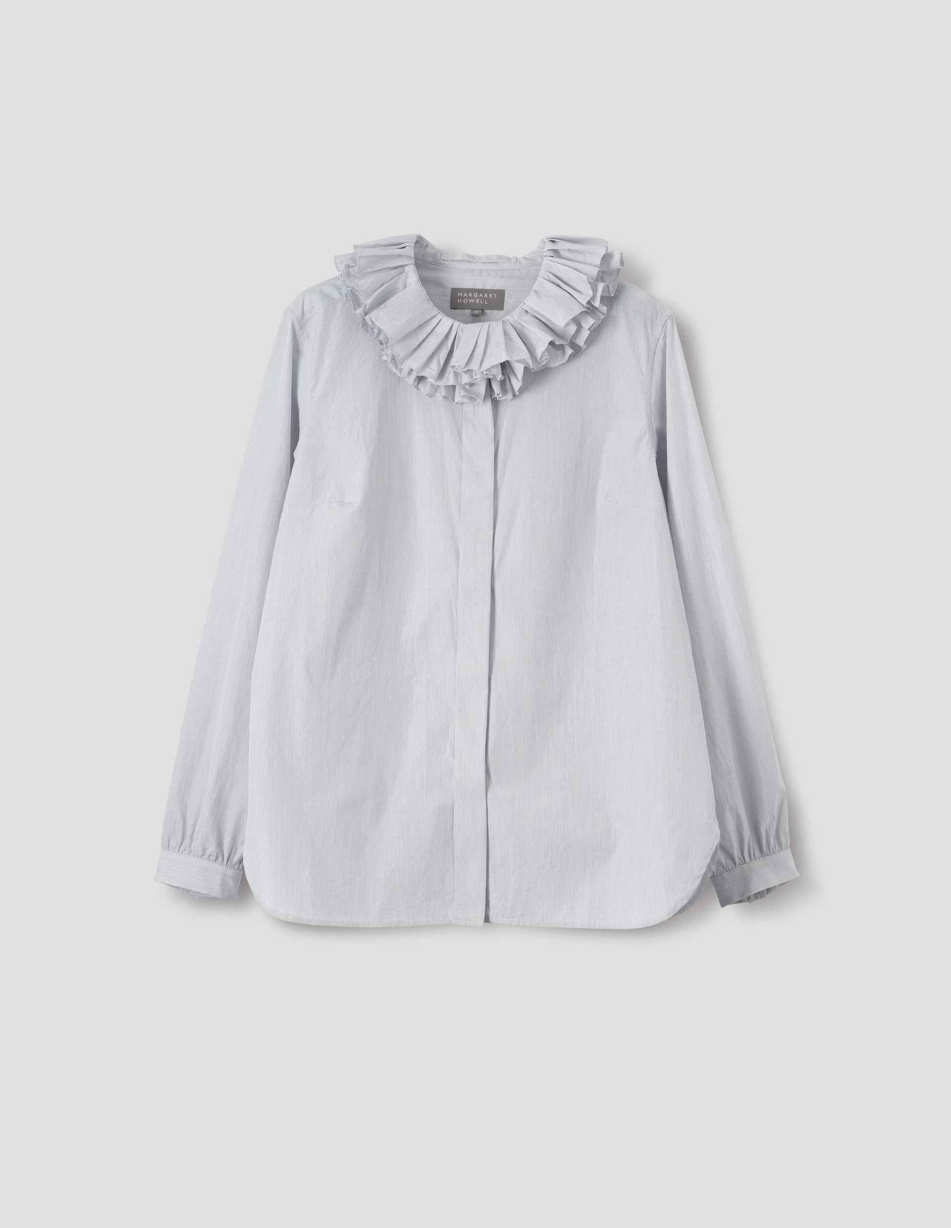 White cotton shirt with dark blue stripes, double ruffle collar, concealed placket with mother of pearl buttons, bracelet-length sleeves with mother of pearl buttons on narrow, gathered cuffs, and with curved hem. Front flat lay view.