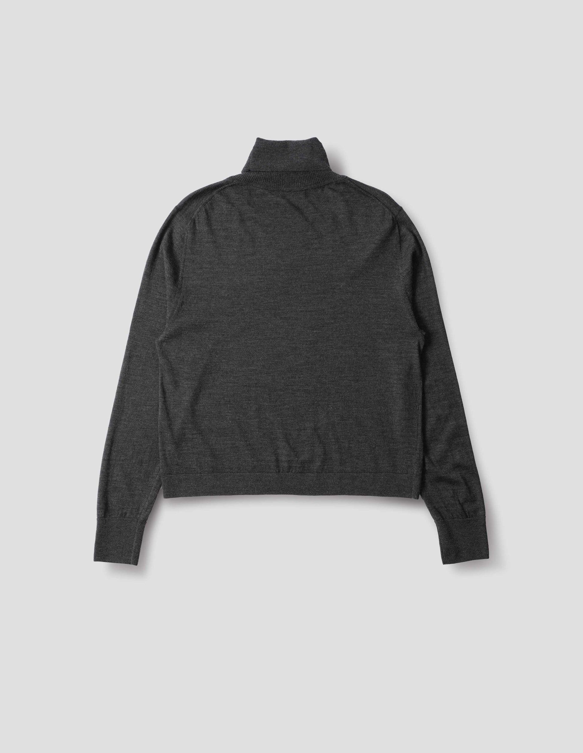 Dark grey merino knitted top with fully fashioned roll neck and armhole, and with ribbed neck, sleeves, cuff and hem. Back flat lay view.