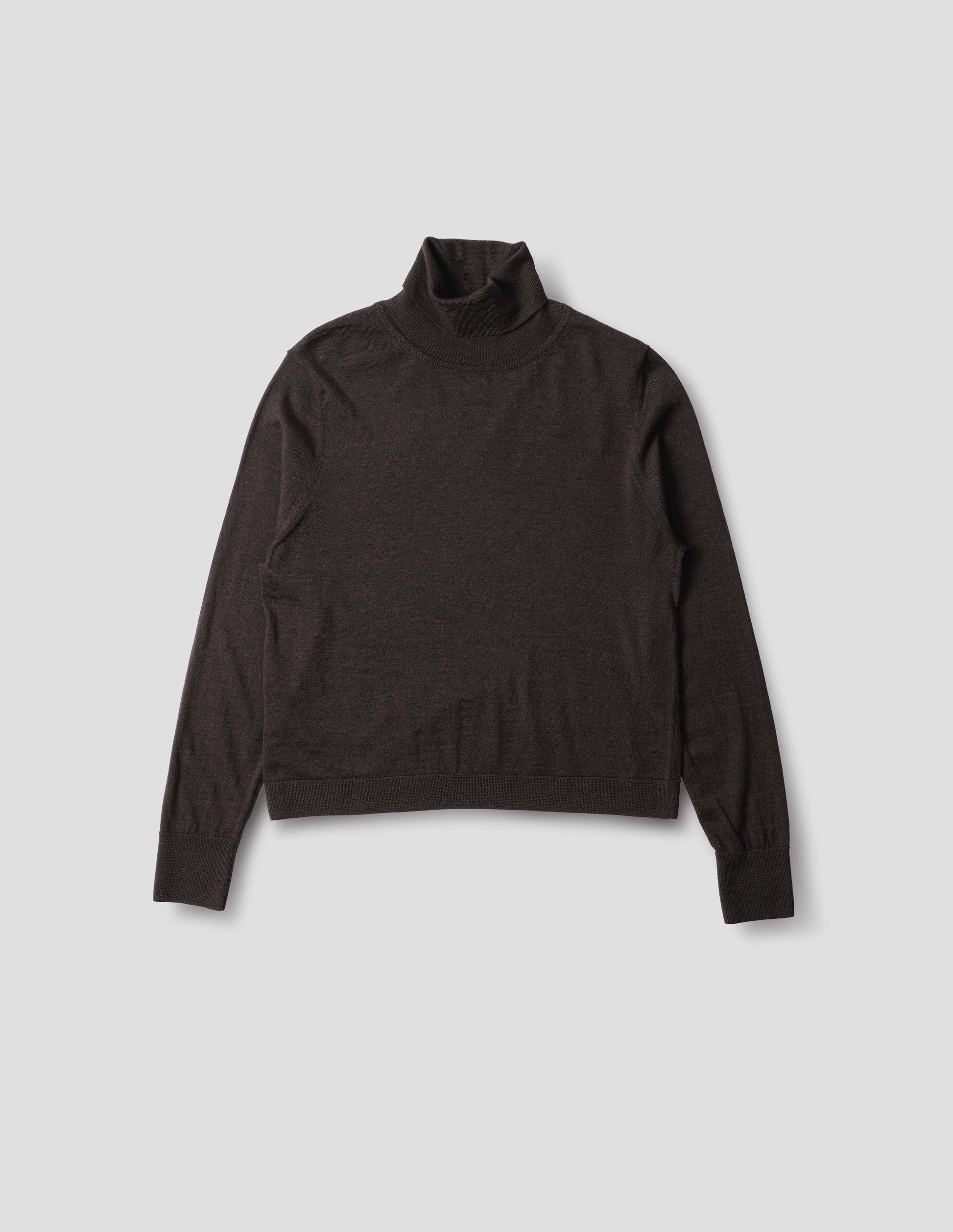 Dark brown merino knitted top with fully fashioned roll neck and armhole, and with ribbed neck, sleeves, cuff and hem. Front flat lay view.