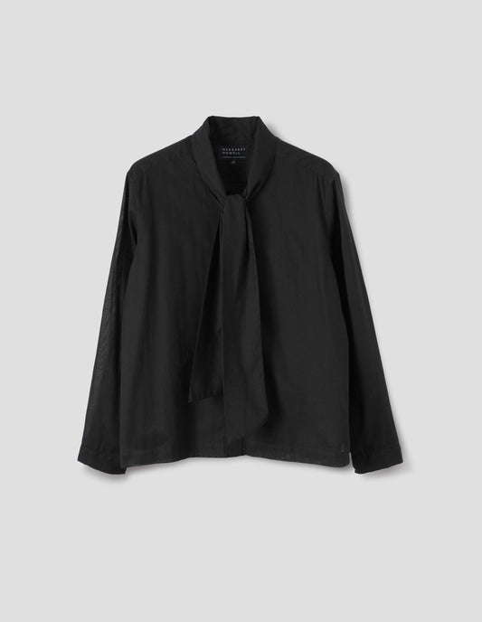 Black cotton cashmere sheer shirt with attached tie that can be worn tied or loose, lipped placket, narrow cuffs and with square side split hem. Front flat lay view. 