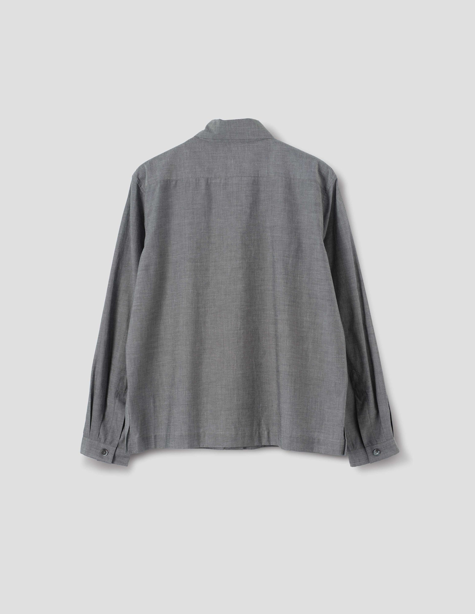 Grey cotton shirt with mother of pearl buttons on narrow cuffs with pleats and with square side split hem. Back flat lay view