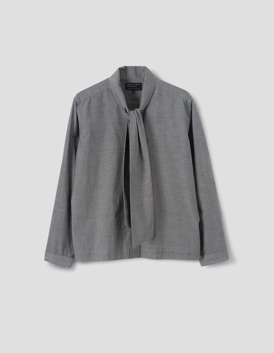 Grey cotton shirt with attached tie that can be worn tied or loose, lipped placket, narrow cuffs and with square side split hem. Front flat lay view. 