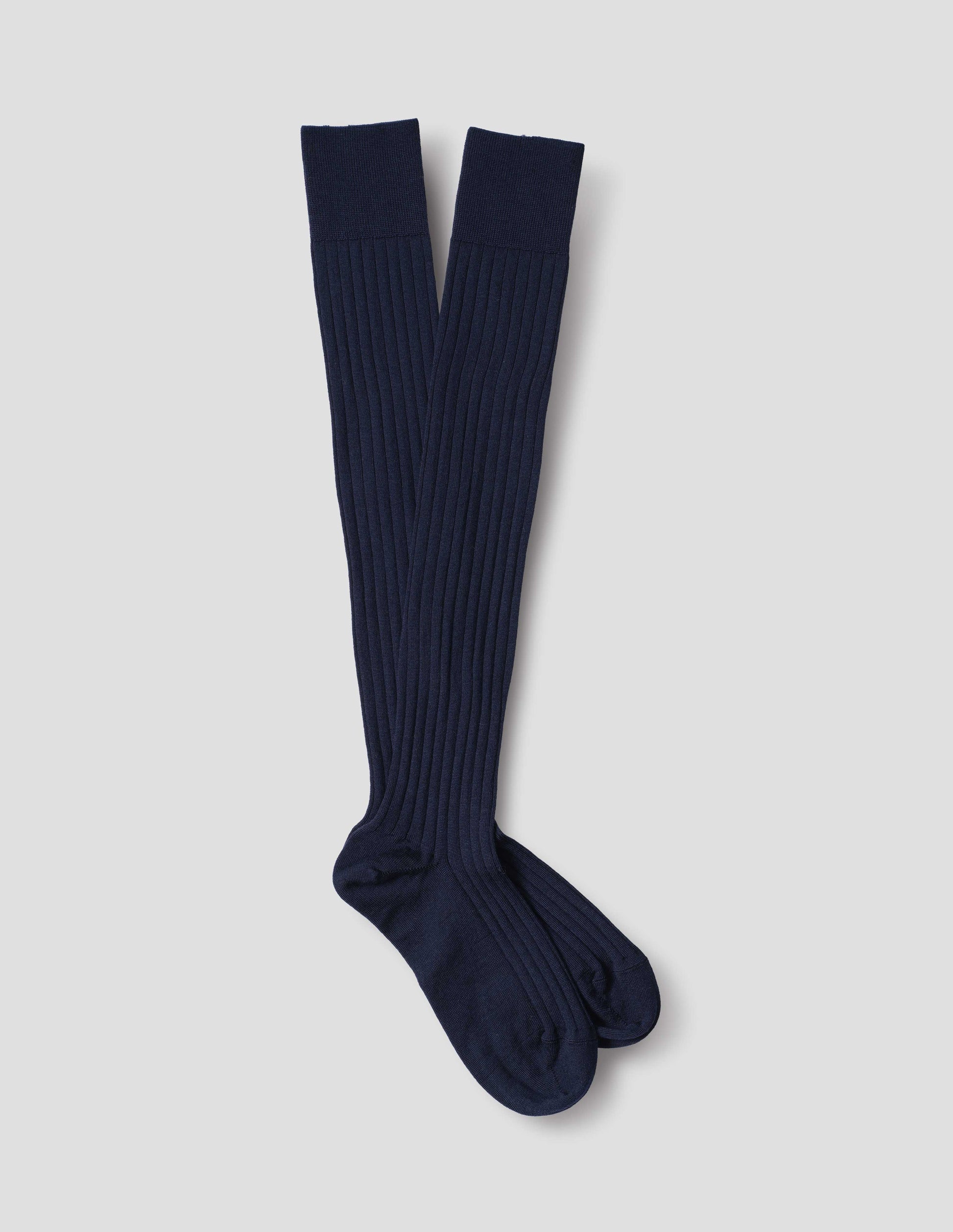 Dark blue wool socks, long and ribbed, front flat lay view.