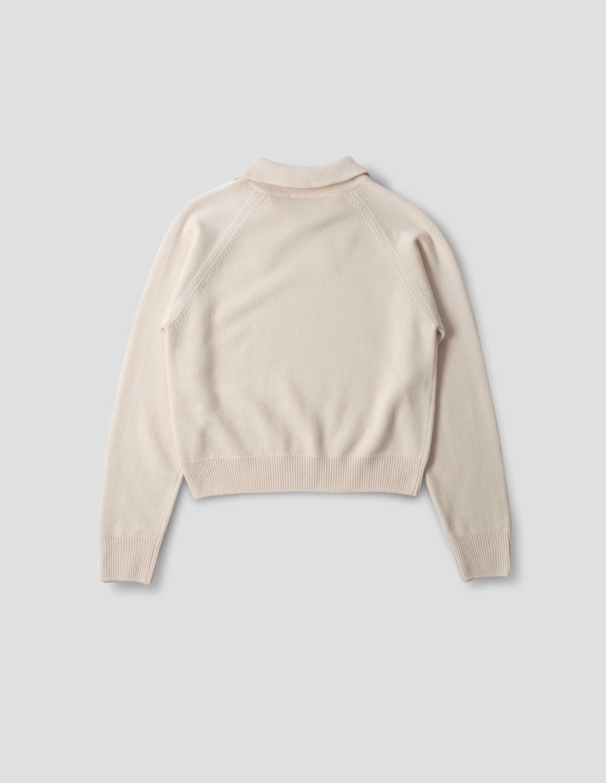 Light beige merino jumper with collar, raglan sleeves, ribbed cuffs and hem. Back flat lay view.