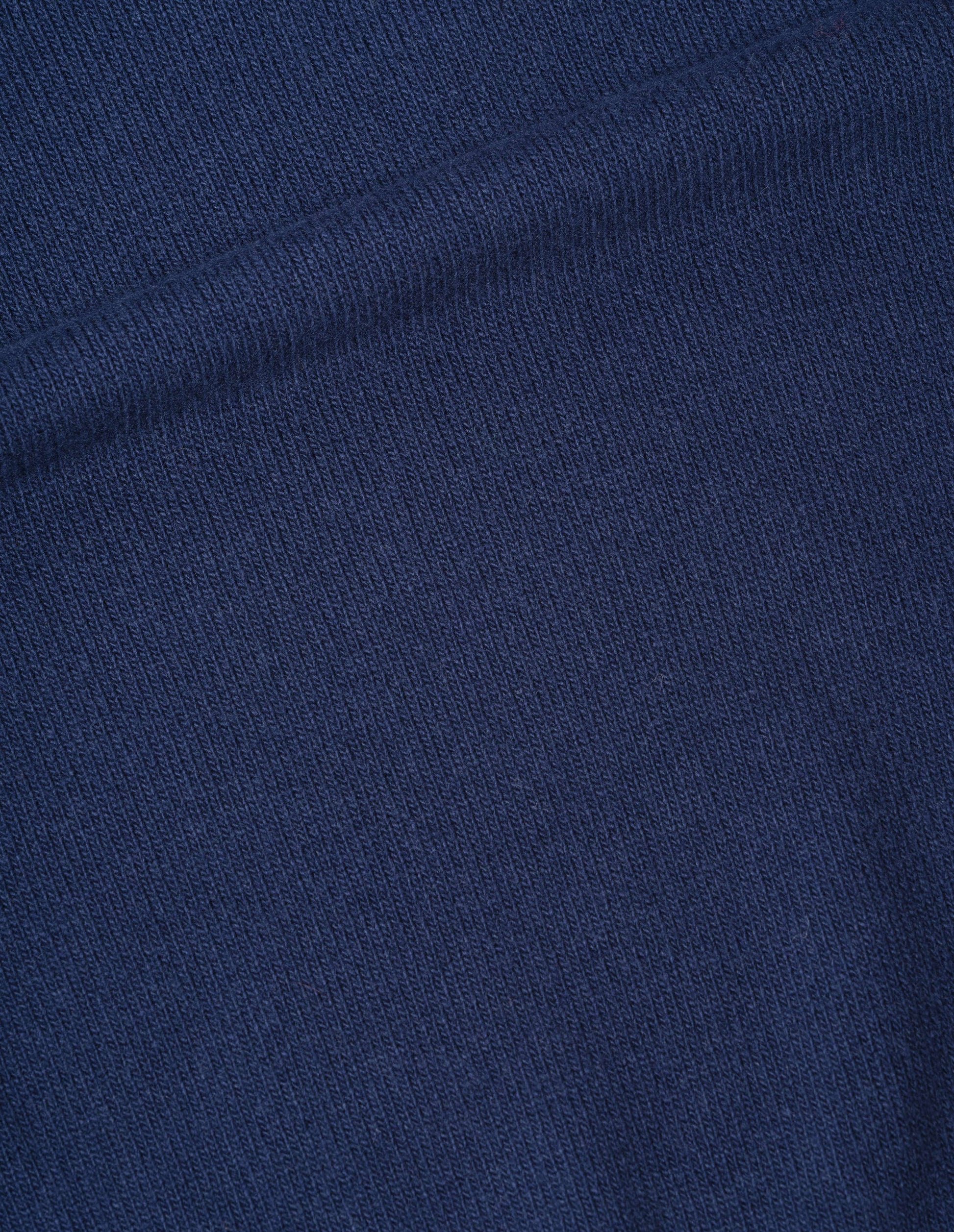 Dark blue soft spun wool jumper fabric swatch.